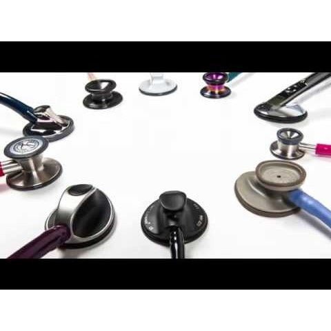 Different Littmann stethoscope heads attached to different coloured stethoscope tubing displayed in a circle against a white background.