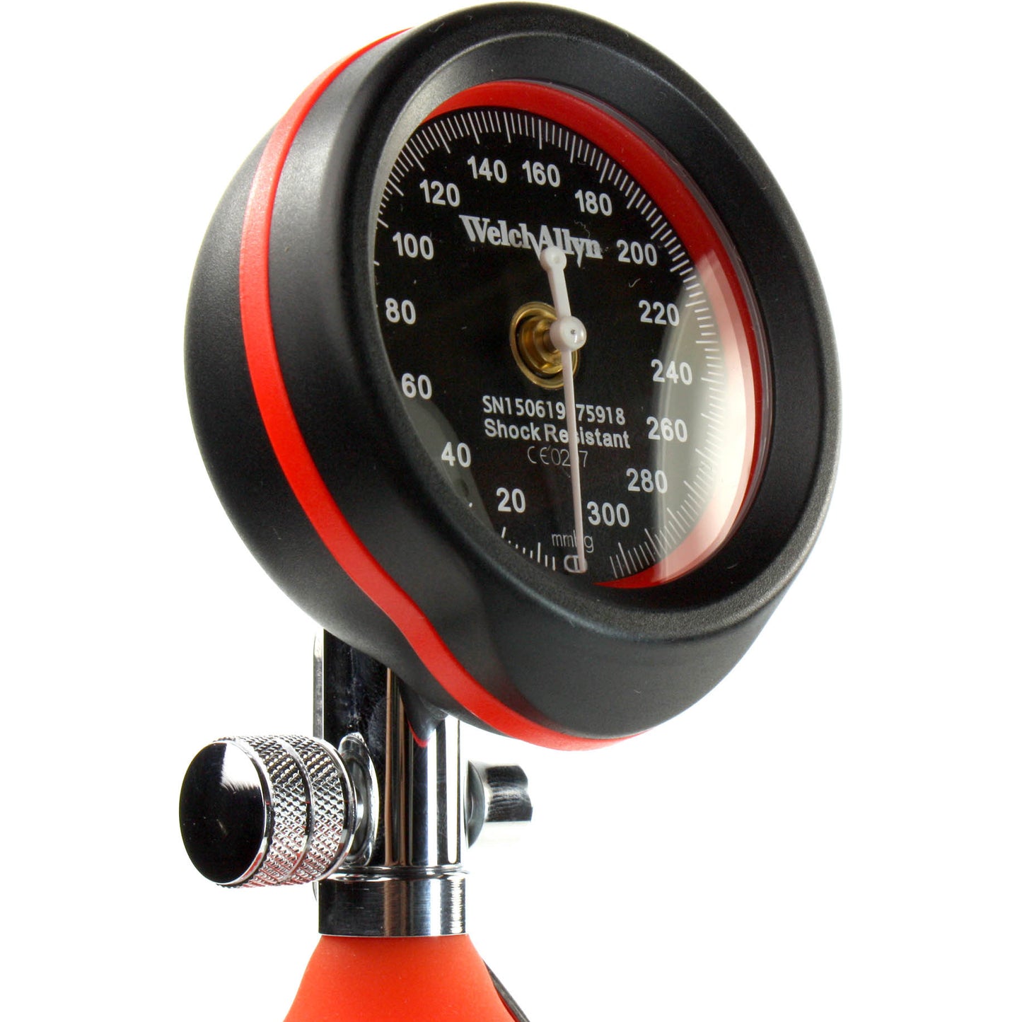 Dial of the red Welch Allyn DuraShock DS55 Sphygmomanometer with the Welch Allyn logo written in white on the black face of the dial. Displayed against a white background.