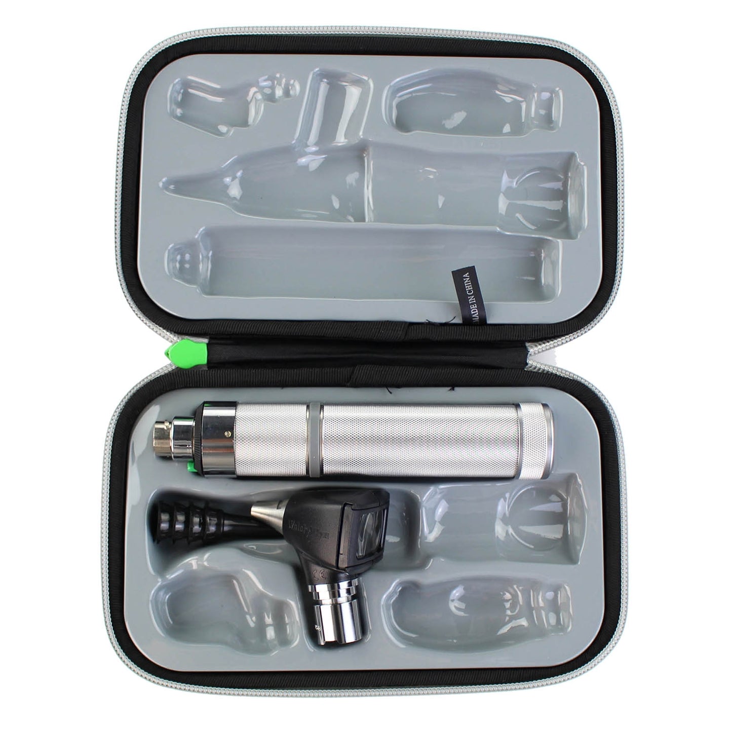 Welch Allyn 3.5v Fibre Optic Otoscope head, four black ear specula and a silver metal handle inside an open diangostic set case. Displayed against a white background.