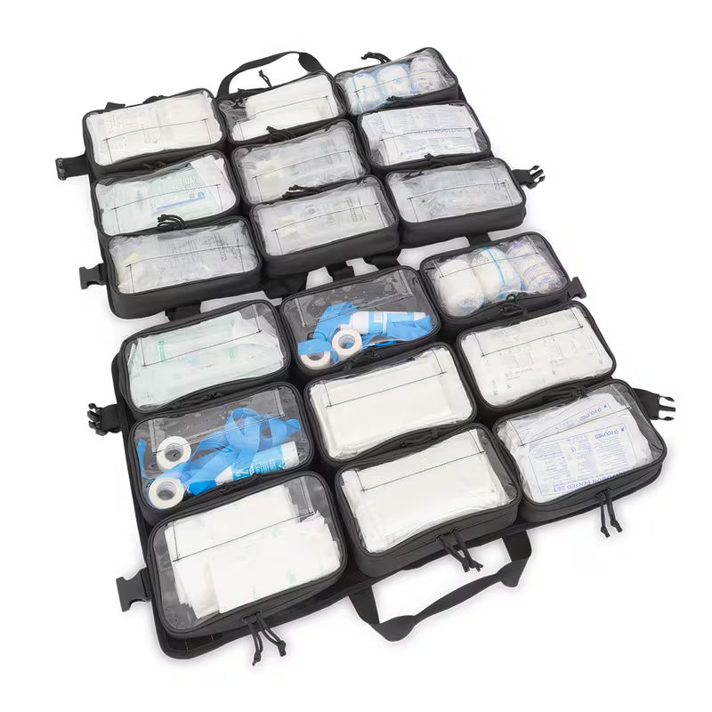 An open black Elite Bags TRIA modular panel with multiple clear plastic compartments containing bandages, gauze, tape, and other medical supplies, photographed on a white background.