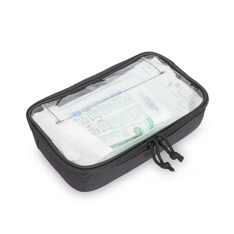 A black Elite Bags rectangular packing cube a clear front window showing white toiletries inside, photographed on a clean white background.