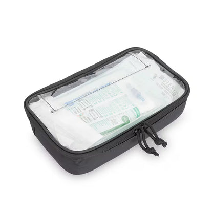 A black Elite Bags rectangular packing cube a clear front window showing white toiletries inside, photographed on a clean white background.