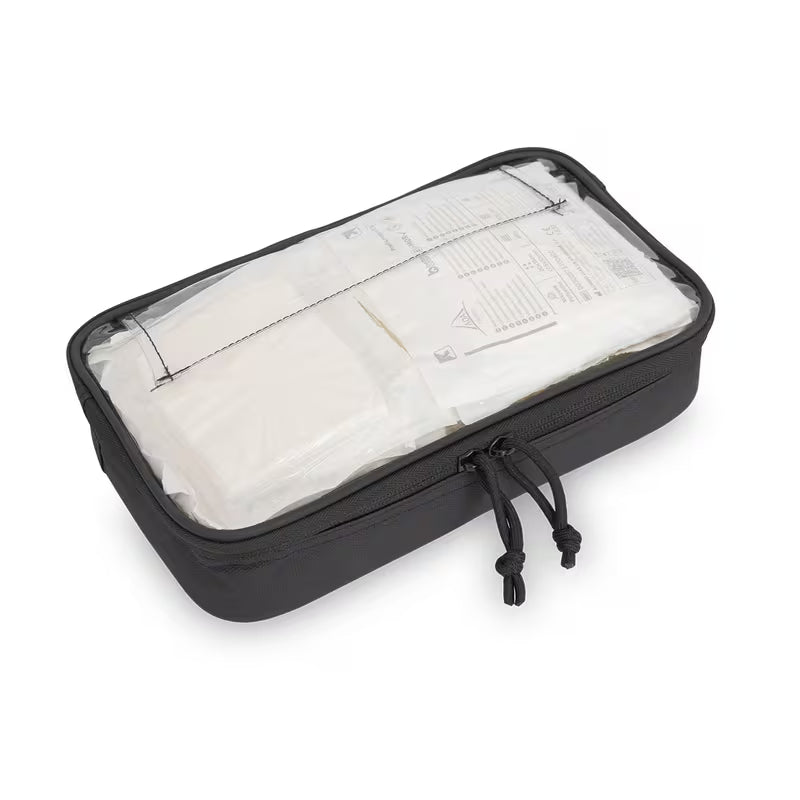 A black Elite Bags rectangular travel packing cube with a clear zippered top, shown on a white background. Inside, white toiletry packets are visible through the transparent window, and a black drawstring is hanging from the zipper.