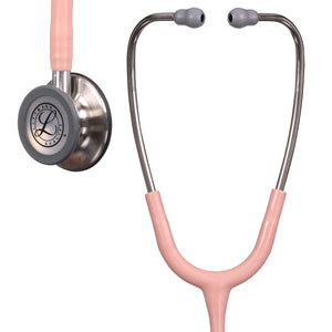 The binurals, bell and some of the tubing of the satin champagne rose Littmann Classic III Monitoring Stethoscope is visible in the image with the Littmann logo clear on the stethoscopes bell.